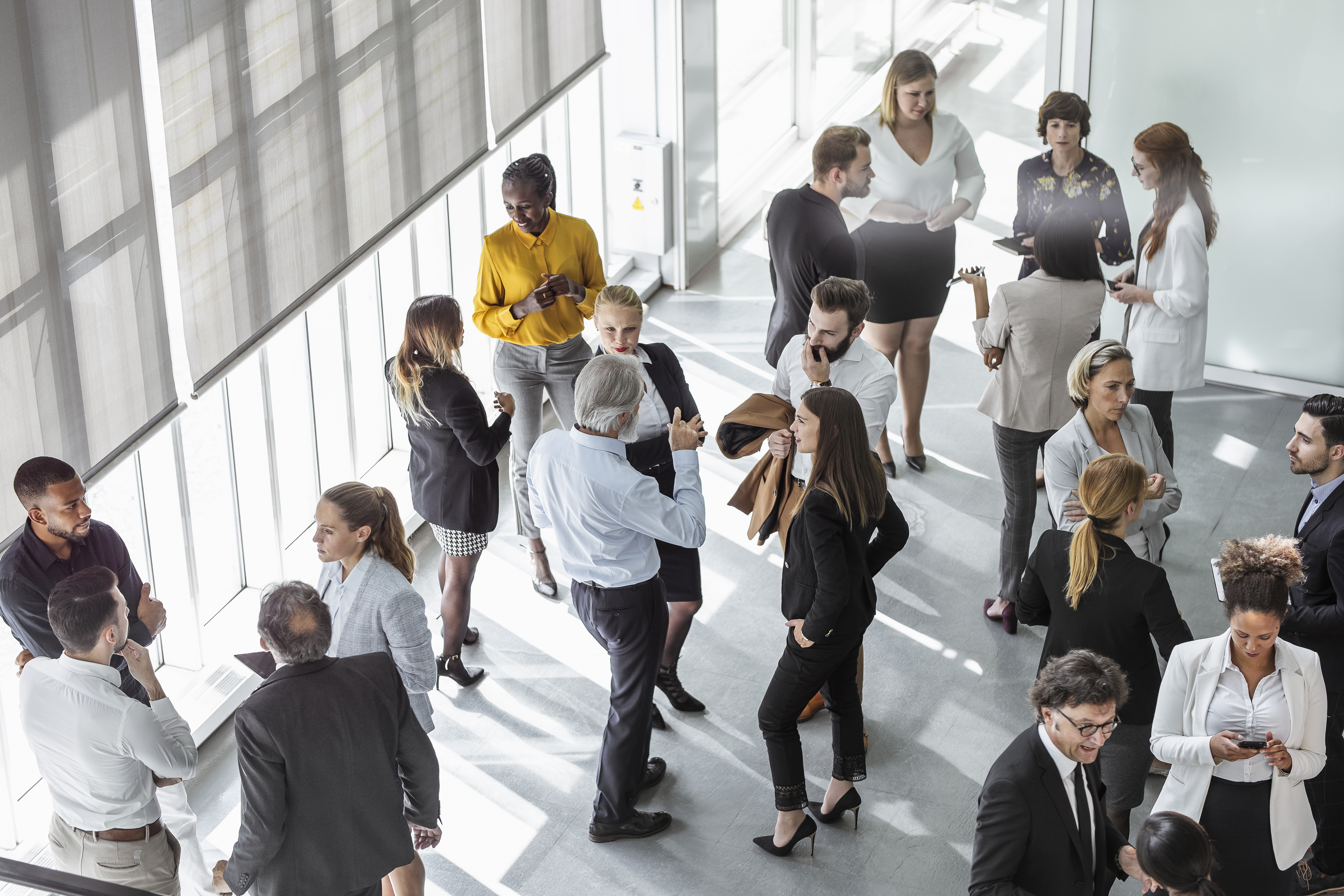 Birds eye view of a room of professional people networking