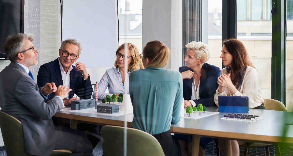 View through a glass wall into a conference room meeting